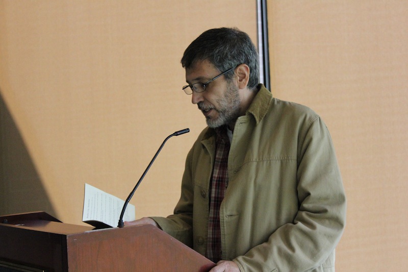 Israel Centeno reading one of his publications (Bamboo City, Summertime)  to the audience. 