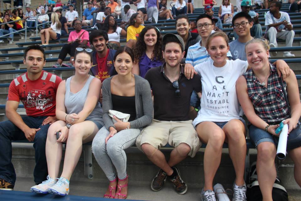 International students gather with a RMU Global Ambassador while bonding at a football scrimmage.