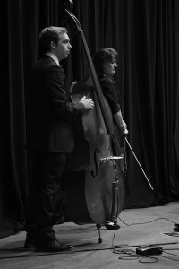 Heather Pinson and Up right bass player listen to the words of Paul Spradley, who describes Dr. Crawley as his greatest mentor. 