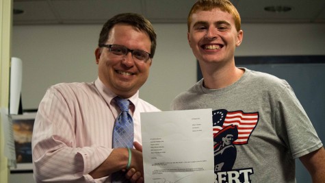 Dr. Anthony Moretti congratulates Nick Buzzelli for winning SCJ Student Journalist of the Year. 