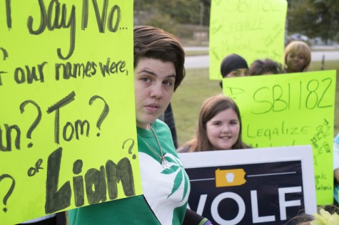 Supporters of Tom Wolf outside WTAE station Wednesday night, holding signs in support of legal, medical marijuana. 