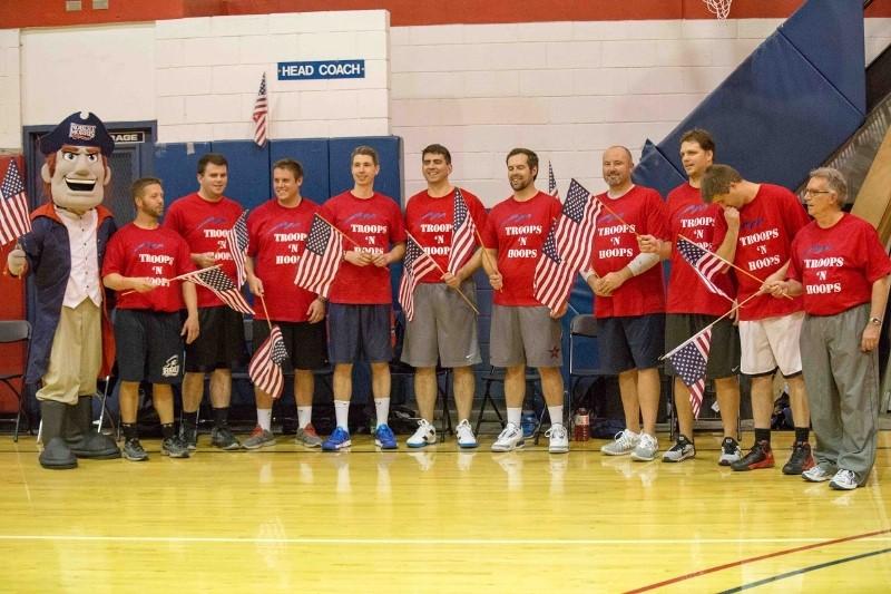 Members of the RMU faculty team await to be introduced prior to the Troops N Hoops charity basketball game Tuesday night.