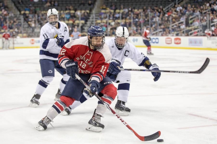 Brady Ferguson stick handles past PSUs David Glen and Patrick Koudys Monday night during RMUs Three Rivers Classic win over the Nittany Lions.