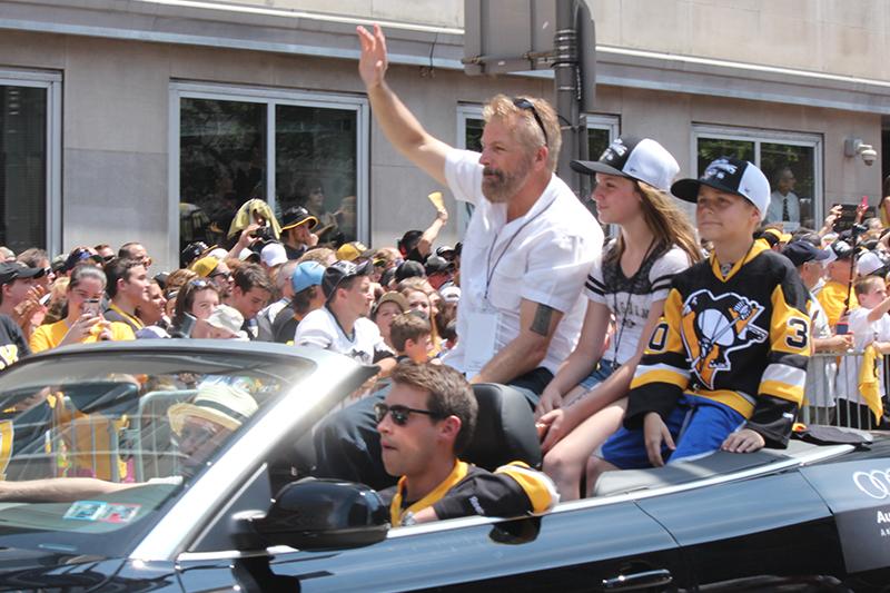 Radio analyst and former Penguin, Phil Bourque, waves to the crowd of Penguins fans.