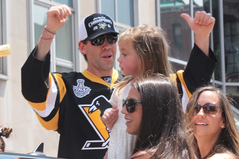 Pascal Dupuis raises his arms to the crowd as they chant his name.
