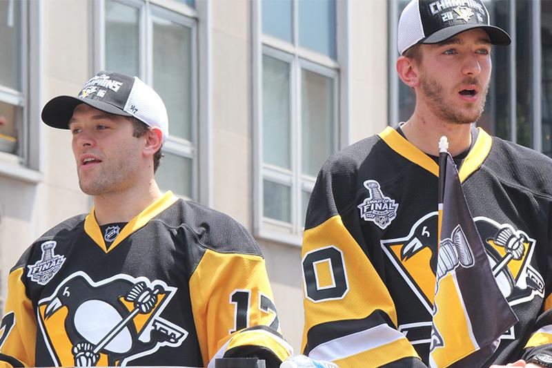 Rookies Bryan Rust (17) and Matt Murray (30), two key contributors to the Penguins playoff success, look over the parade crowd.