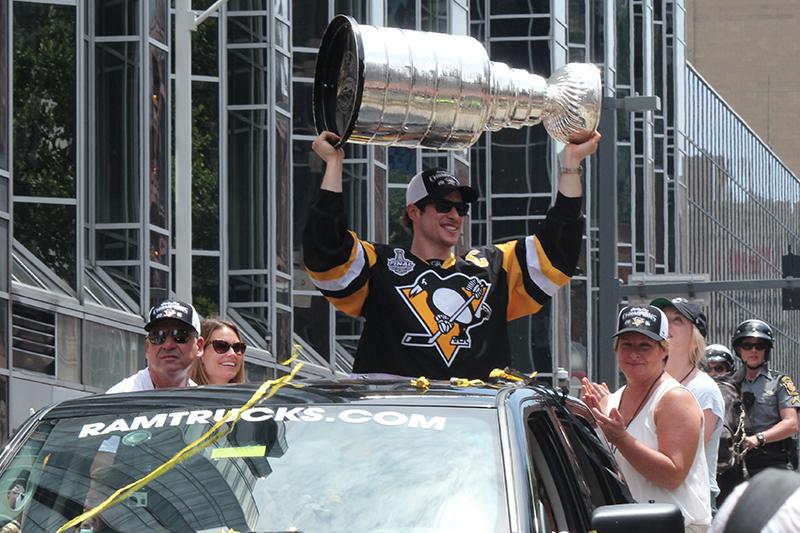 Sidney Crosby shows off the Stanley Cup to a sea of Penguins fans.