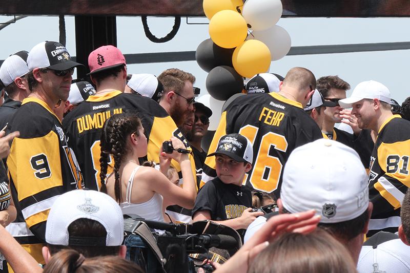 Pascal Dupuis (9), Brian Dumoulin (8), Eric Fehr (16) and Phil Kessel (81) converse as they await the arrival of the rest of their teammates.