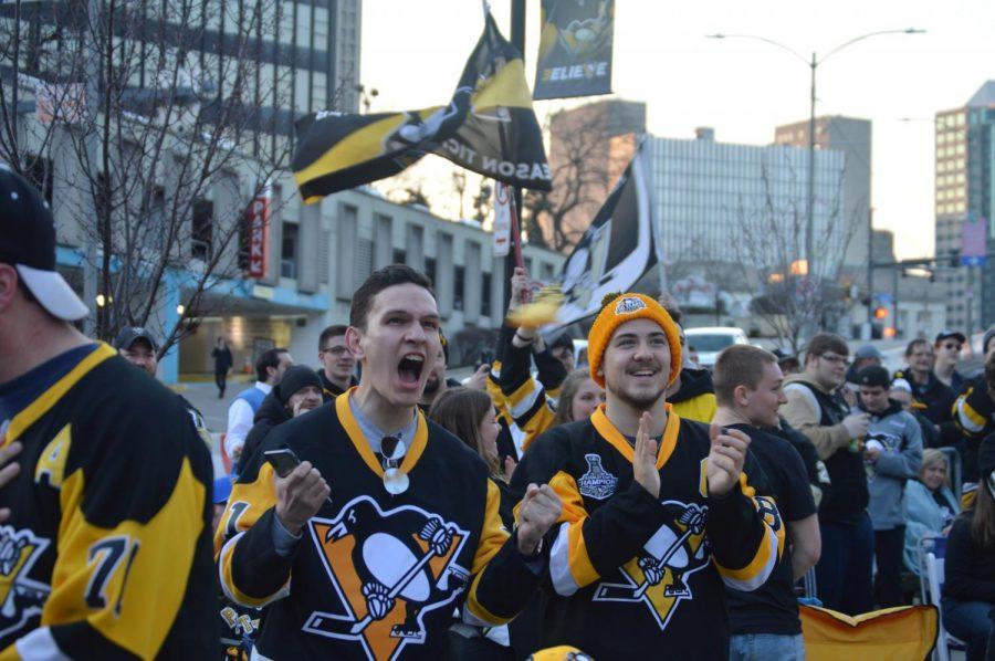 Penguin fans show their support as they watch the game on the big screen.