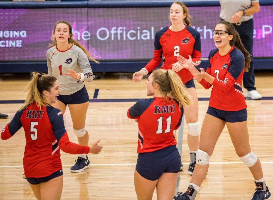 Emily Devlin (11) and Maria Alfano (7) celebrate with Alyson Londot (2), Nikolette Zanolli (1) and Whitney Brown.