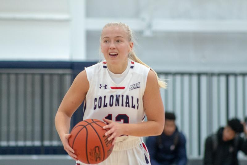 Nina Augustin holds the ball on the court against the La Salle Explorers.