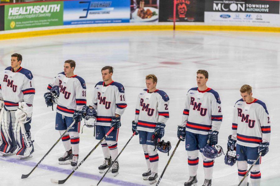 The+Robert+Morris+Mens+hockey+team+stands+in+unison+at+the+blue+line+during+the+playing+of+the+National+Anthem+at+Colonials+Arena.