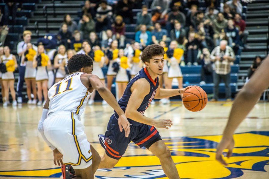 Dante Treacy surveys the Drexel defense in the Colonials 82-69 loss to the Dragons.
