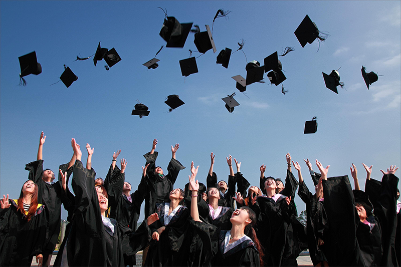 Newly+Graduated+People+Wearing+Black+Academy+Gowns+Throwing+Hats+Up+in+the+Air.+Photo+Credit%3A+%28Pexels%29