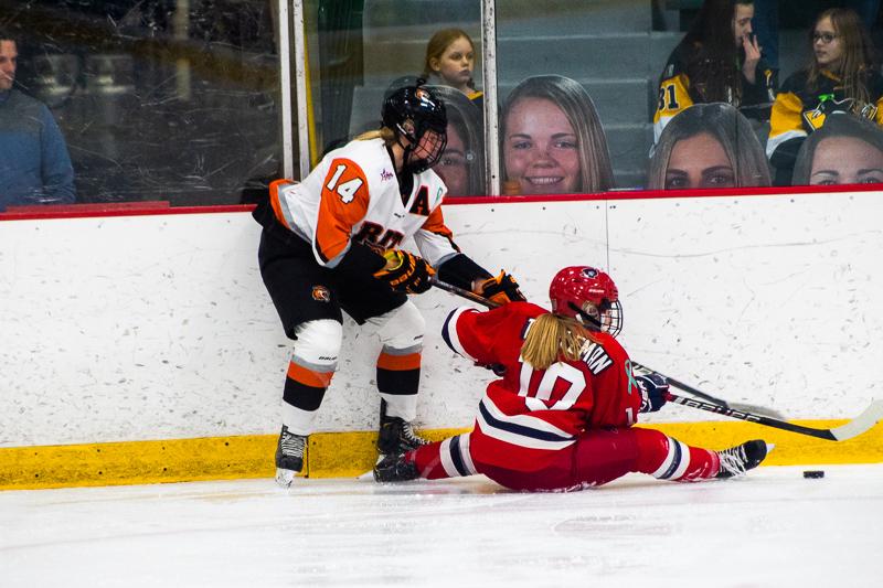 Lexi Templeman stretches out on the ice, fighting for the puck. Neville Island, PA Friday Jan. 25, 2019. (RMU Sentry Media/Samuel Anthony)