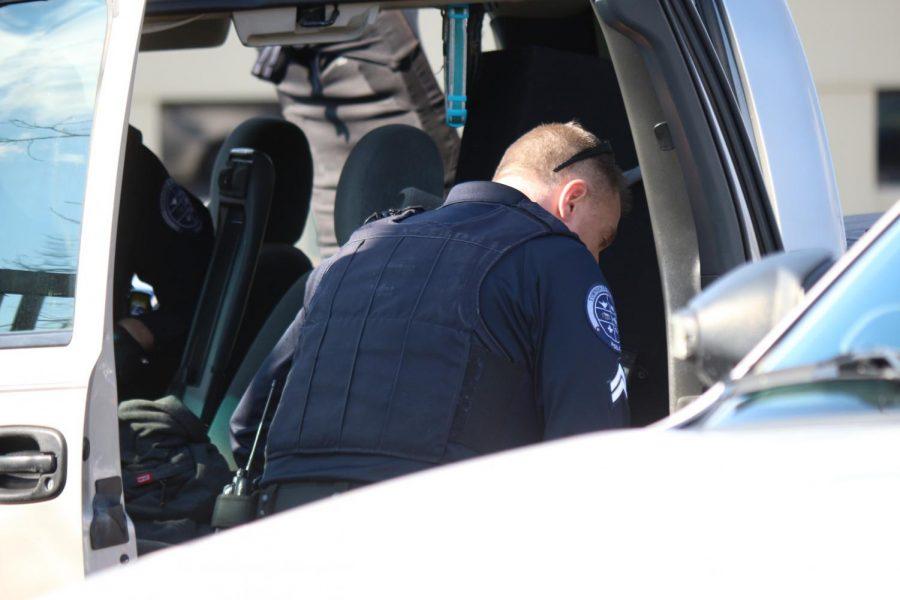 Moon Township and Robert Morris Police search a vehicle in the parking lot of the Benjamin Rush Center.