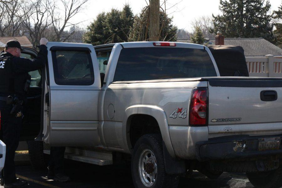 Moon Township and Robert Morris Police search a vehicle in the parking lot of the Benjamin Rush Center.