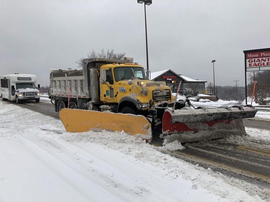 A PennDOT plow truck is using both of its plows to help clear University Boulevard in Moon Township. Photo Credit: (RMU Sentry Media/Gage Goulding)