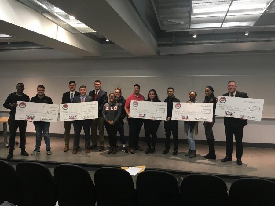 A group shot of the presenters receiving their big checks at the Shark Tank.