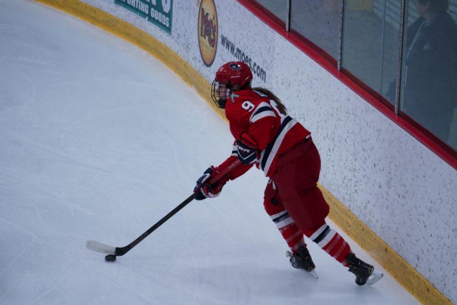 PITTSBURGH -- Maggie Lague (pictured) skates with the puck against RIT on January 25, 2019 (Tim Kelly/RMU Sentry Media)