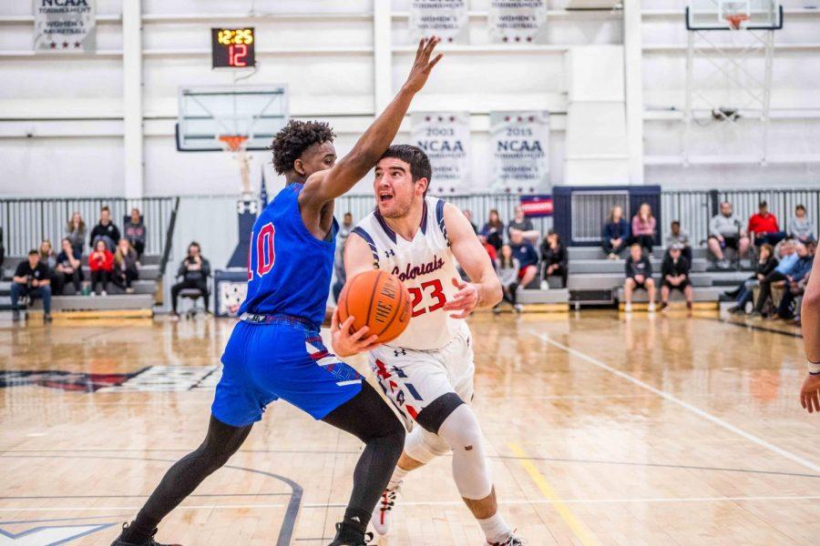 MOON TOWNSHIP -- Matty McConnell (23) drives to the hoop against Presbyterian Colleges Adam Flagler (10) on March 24, 2019 (David Auth/RMU Sentry Media).