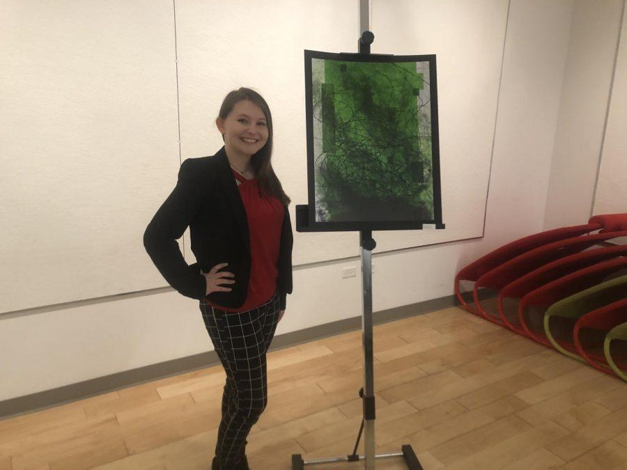 MOON TOWNSHIP — Student Ali Cannon next her artwork, There is no True Student-Loan Crisis (Logan Carney/RMU Sentry Media).