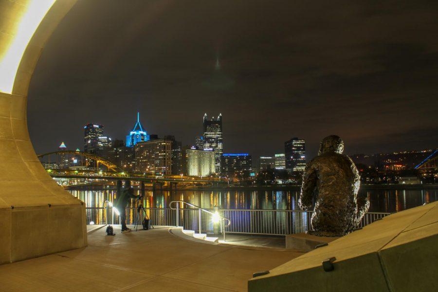 A statue of Mister Rogers looks over the Downtown Pittsburgh skyline from the Fred Rogers Memorial Statue on the North Shore. Photo Date: March 29, 2019 Photo Credit: (RMU Sentry Media/Gage Goulding)