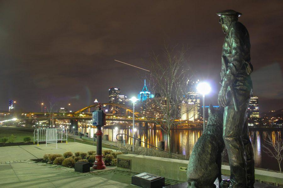 A monument of a police officer and their K9 dog watch over Downtown Pittsburgh from the Allegheny County Law Enforcement Officers Memorial on the North Shore. Photo Date: March 29, 2019 Photo Credit: (RMU Sentry Media/Gage Goulding)