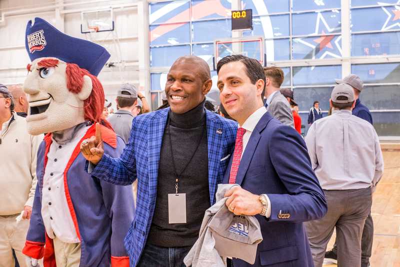 Coach Buscaglia celebrates the NEC title with RMU President Christopher Howard. Moon Township, PA March 17, 2019 (David Auth/RMU Sentry Media)