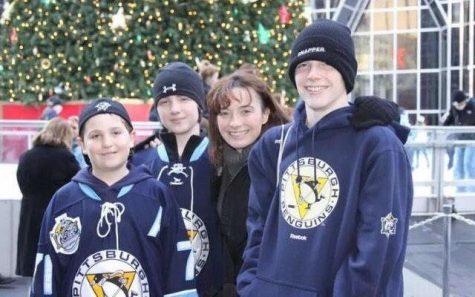 A picture of my brothers, my mom, and myself. My mother was the most inspirational person I ever met, and this moment around the Winter Classic at the ice skating rink is one of many great memories spent with her.