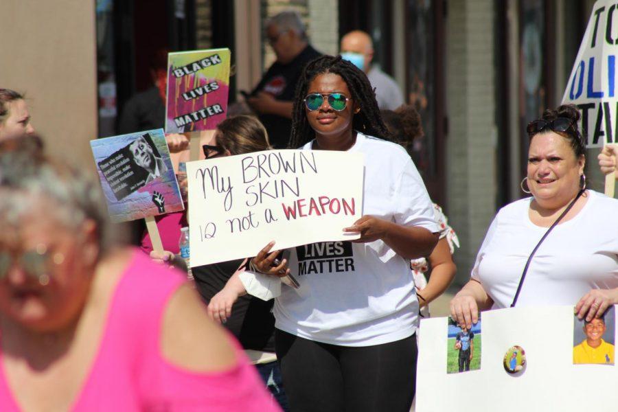 A marching protester carries a sign reading My brown skin is not a weapon.Coraopolis, PA. June 6, 2020. RMU Sentry Media/Garret Roberts 
