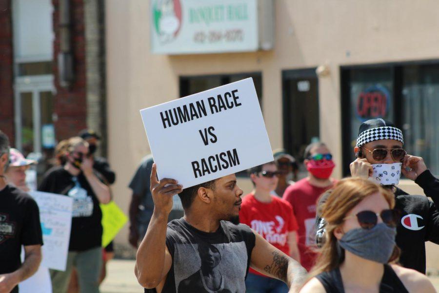 A protester raises his sign, which reads human race vs racism, as the crowd marches. Coraopolis, PA. June 6, 2020. RMU Sentry Media/Garret Roberts 