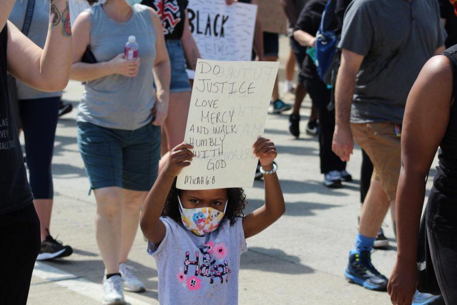 A young protester raises her sign during protest, quoting scripture that calls for peace. Coraopolis, PA. June 6, 2020. RMU Sentry Media/Garret Roberts 