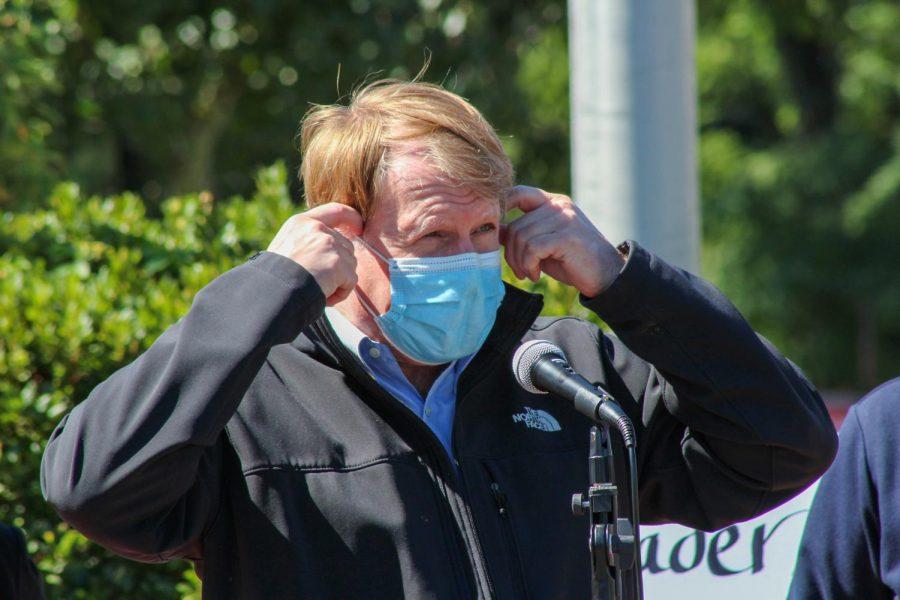 Allegheny County Executive Rich Fitzgerald walks up to the microphone before removing his mask to speak to the audience. 