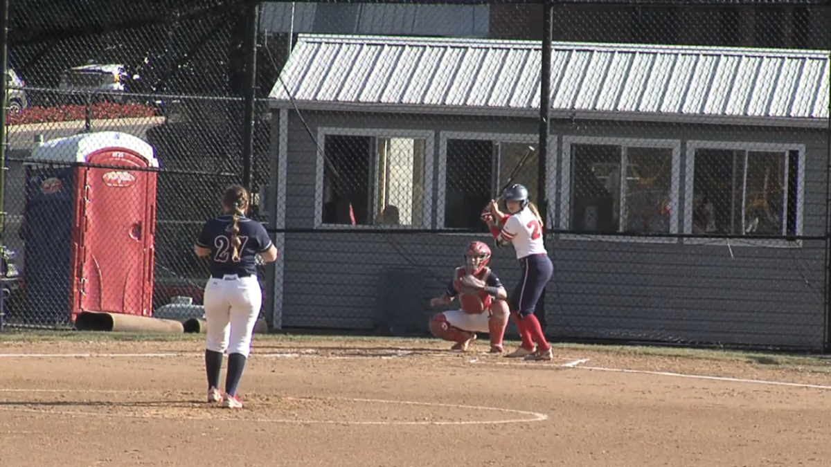 Rachael Rhinehart (27) deals to Natalie Higgins (26) before one of her two home runs