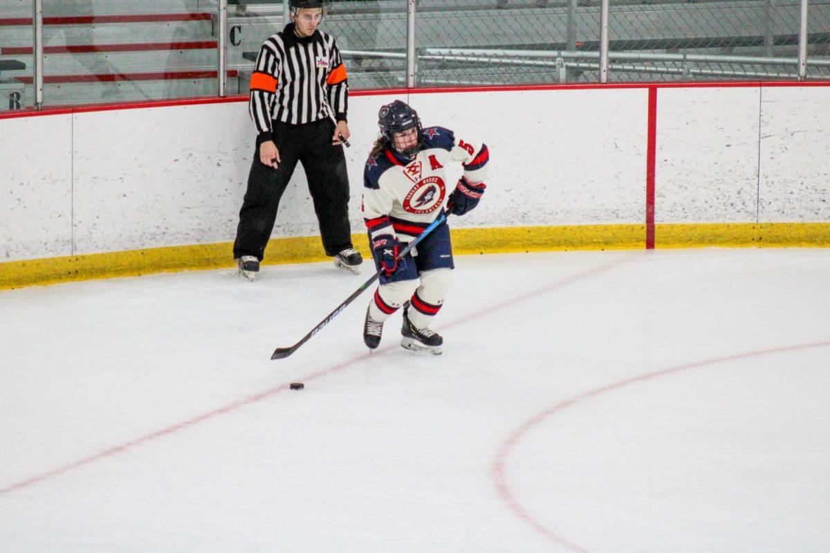 Emily Curlett carries the puck against Lindenwood. Photo Credit: Nathan Breisinger