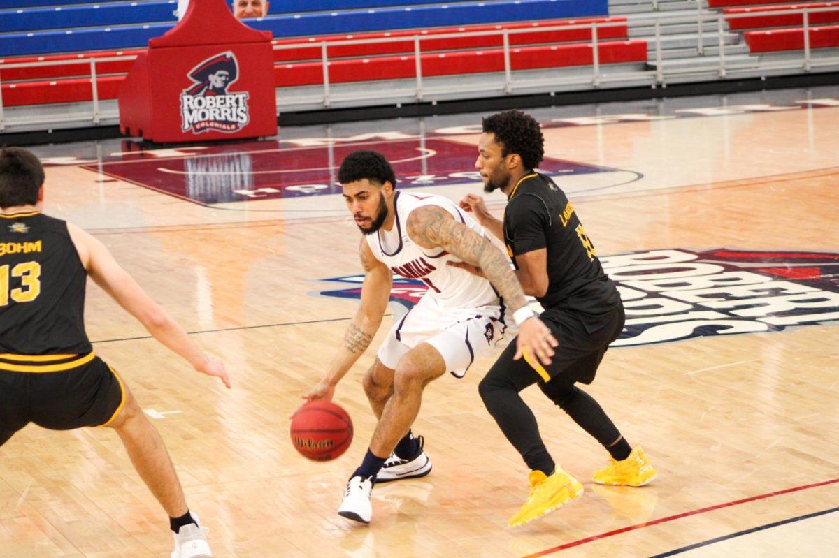 AJ Bramah fends off Bryson Langdon of Northern Kentucky. Bramah dropped 27 points in the 81-76 loss. Photo Credit: Tyler Gallo