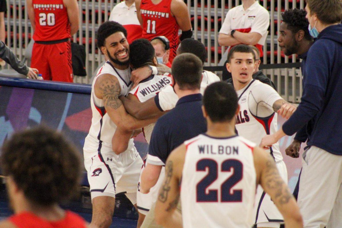 Jon Williams is embraced by AJ Bramah as they celebrate one of his two buzzer-beaters on the night. Photo Credit: Tyler Gallo