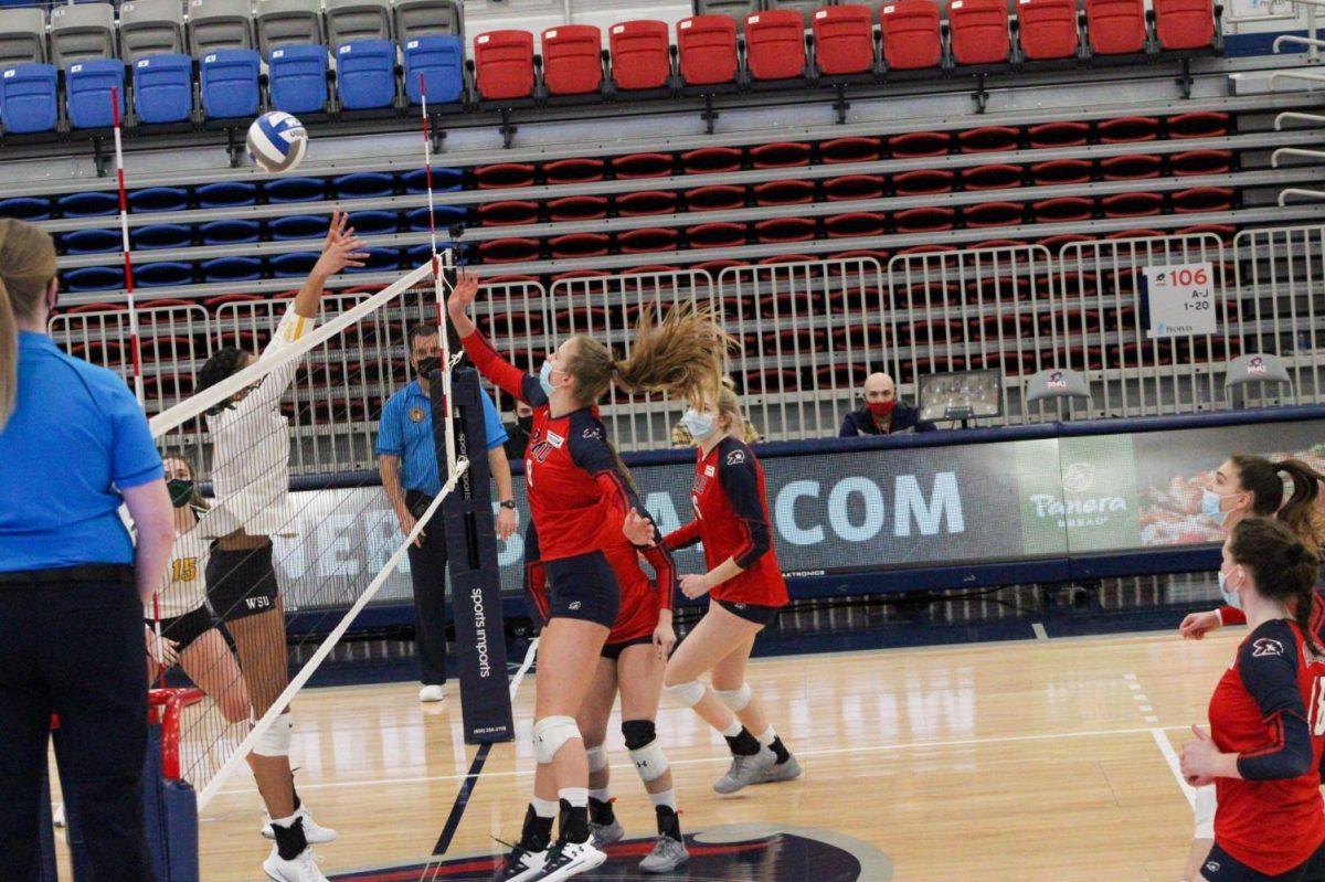 Alyssa Hudak attempts a spike. Photo Credit: Tyler Gallo