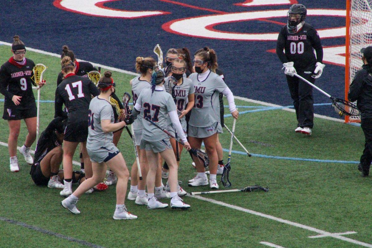The womens lacrosse team celebrates Melanie Gandys second-half goal on Sunday, one of her seven points. Photo Credit: Tyler Gallo