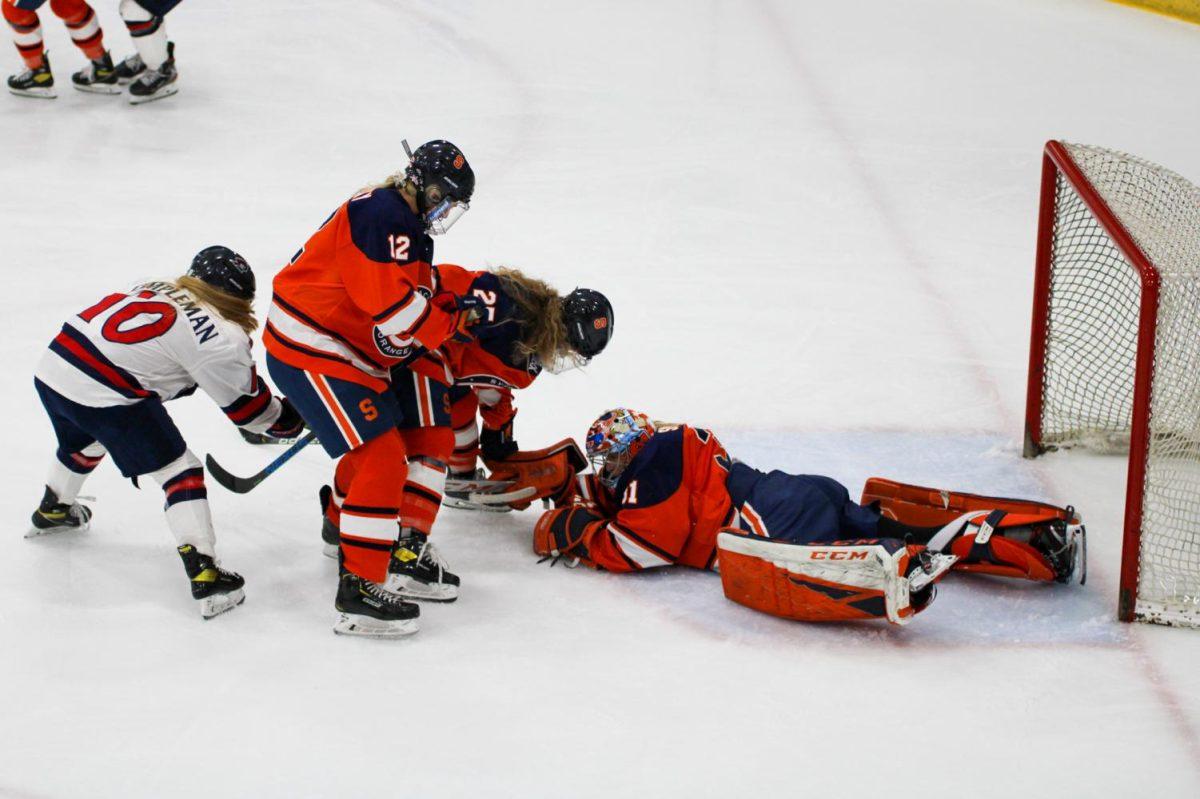 Allison Small covers the puck after one of her 49 saves on Friday. Photo Credit: Nathan Breisinger