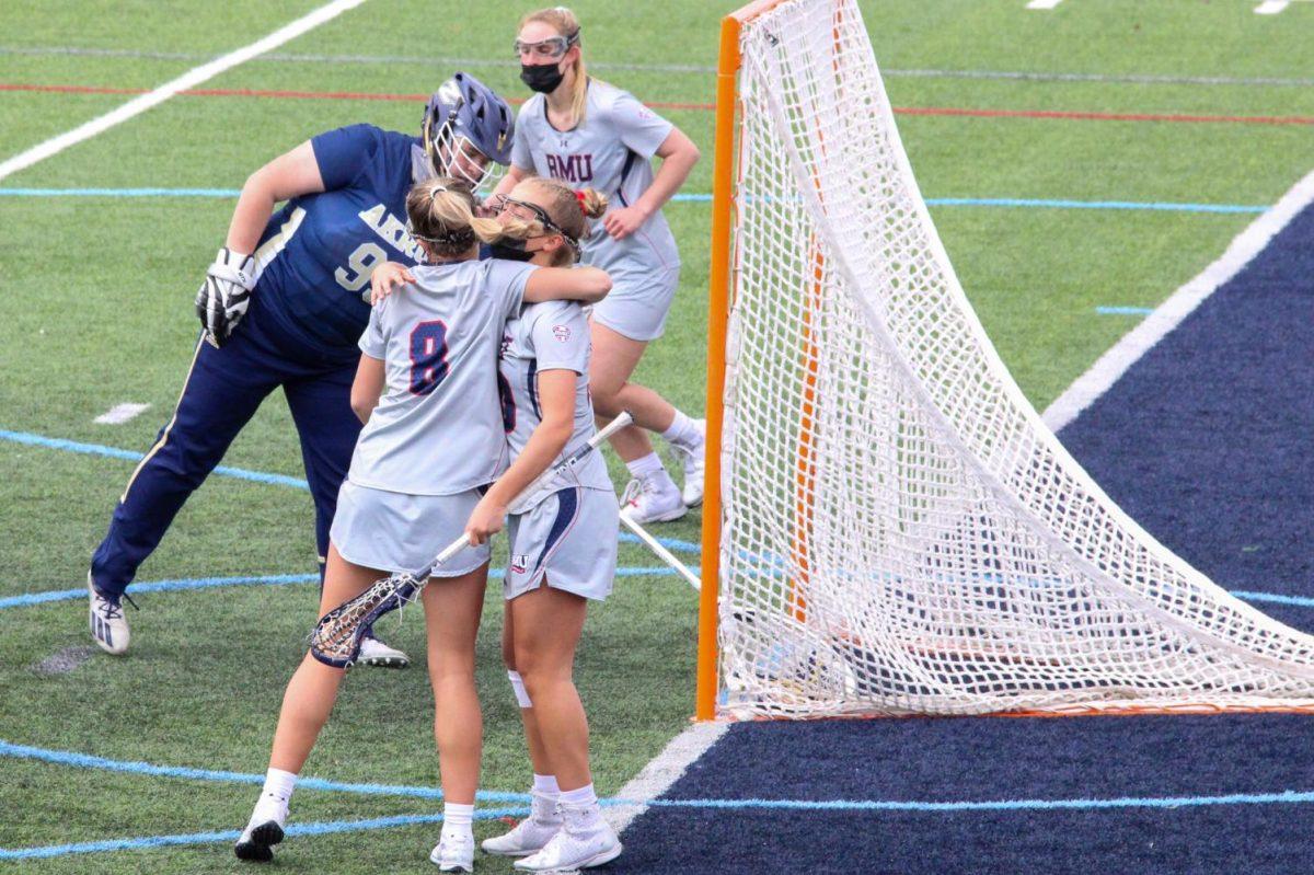 Melanie Gandy and Julia Koterwas celebrate a goal against Akron. Photo Credit: Nathan Breisinger