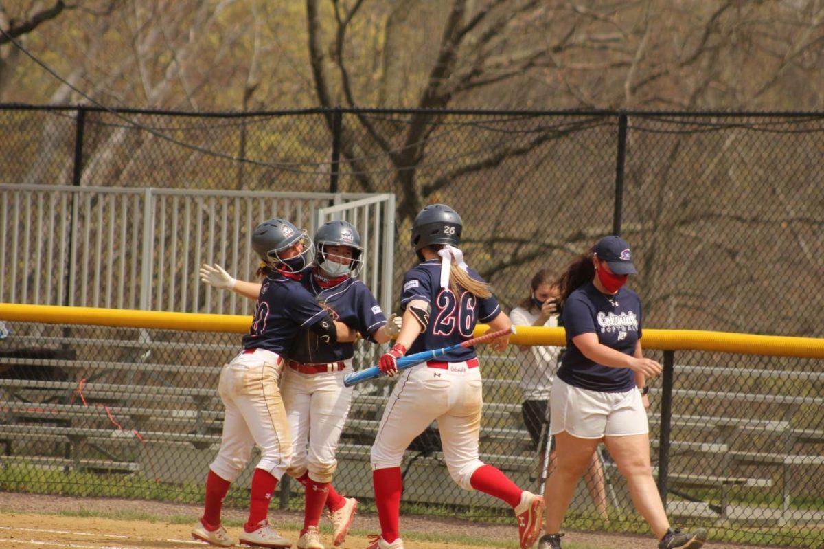 Softball embraces Faith Miller after her walk-off single against UIC. Moon Township, PA 4/10/2021 (Ally Yovetich)
