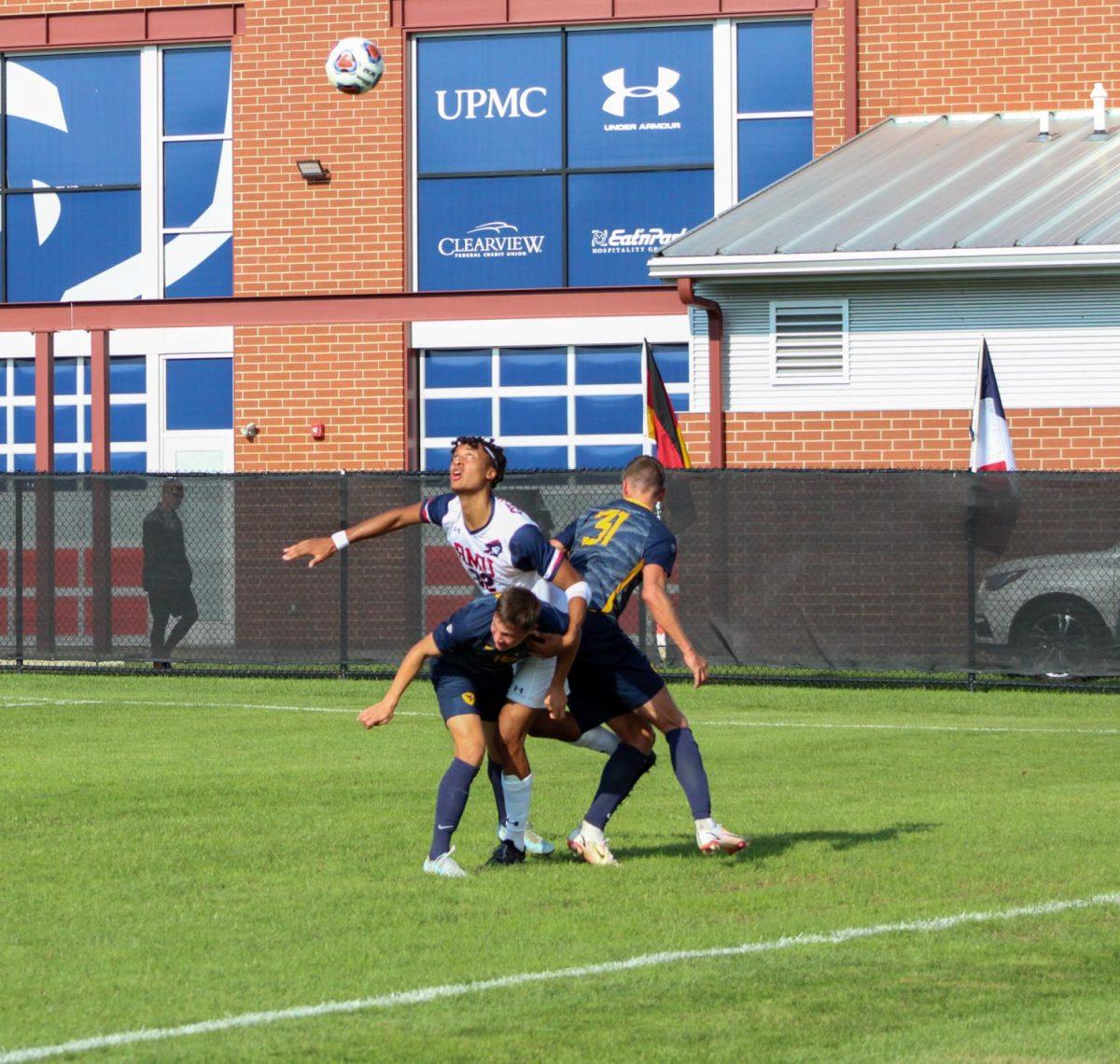 Hugo Kadima is smothered by two West Virginia players. Photo Credit: Samantha Dutch/Colonial Sports Network