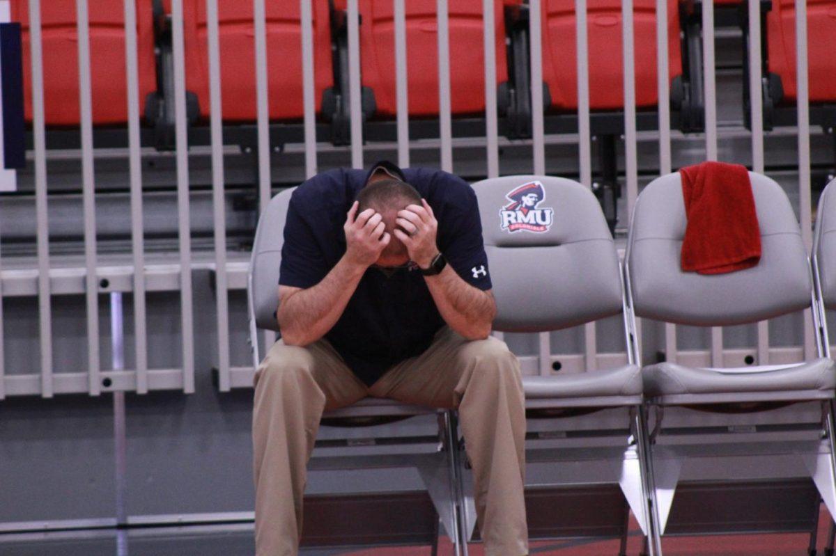 Head coach Dale Starr puts his head down in disgust after the Colonials blew a late lead in their third set.