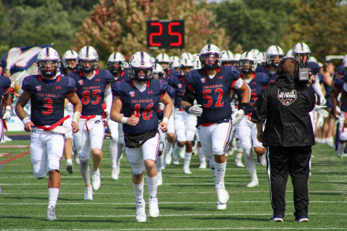 Football runs in from the locker room before their game against Howard.