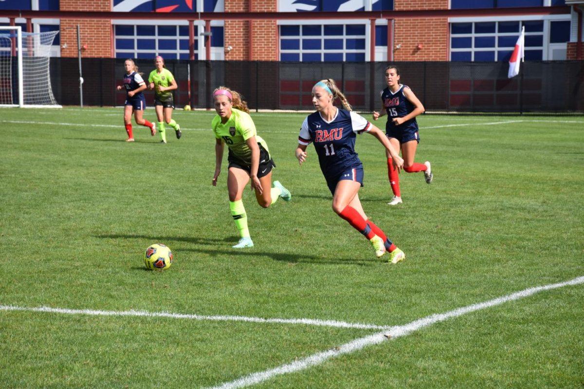 Sheridan Reid and Sydney Grodsinsky chase after the ball.