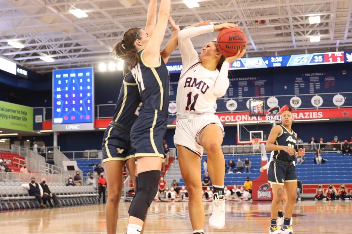 Natalie+Villaflor+drives+to+the+hoop+against+Akron.+Photo+credit%3A+Ethan+Morrison