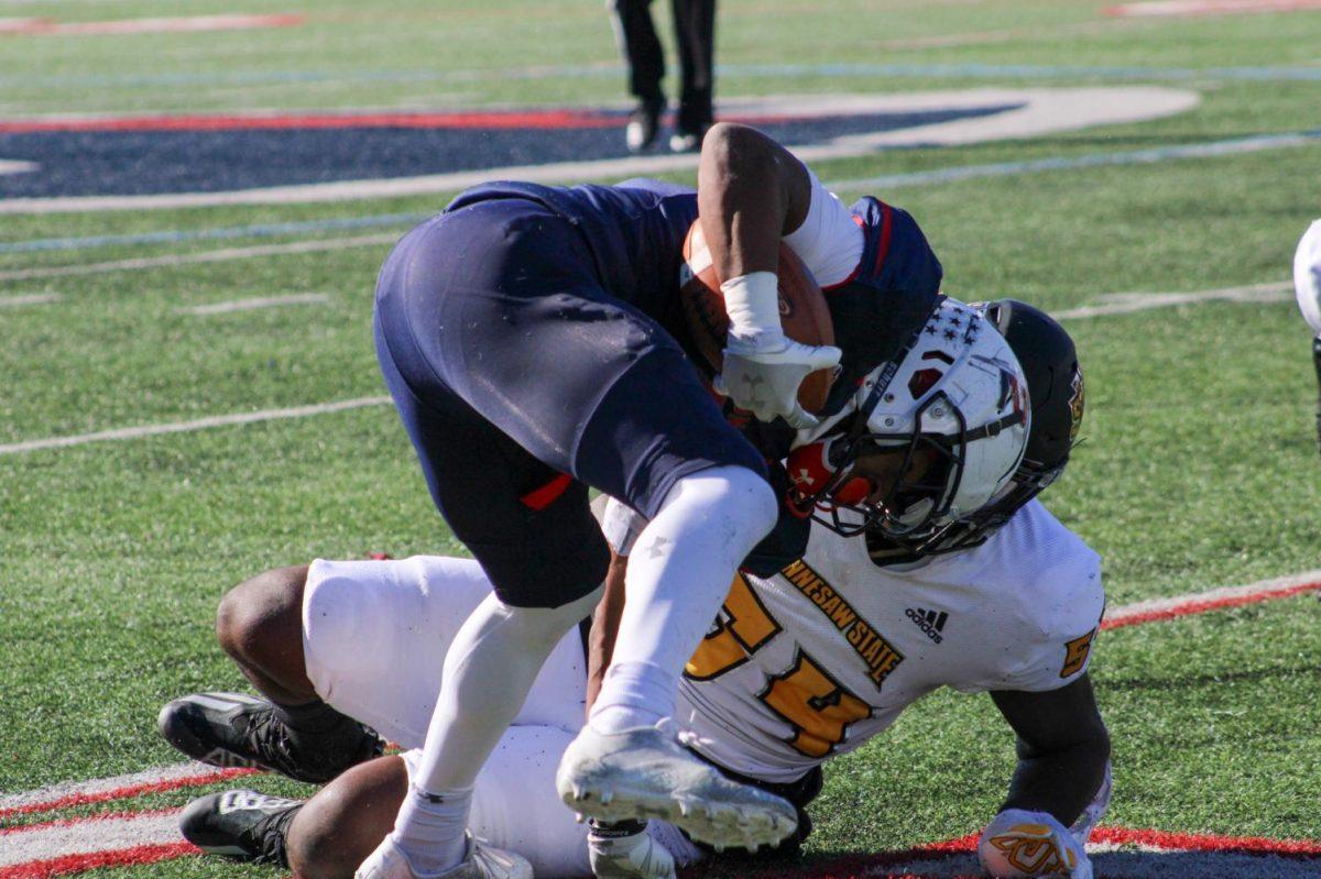 Alijah Jackson is tackled by Kennesaw States Tyler Moore. Photo credit: Tyler Gallo