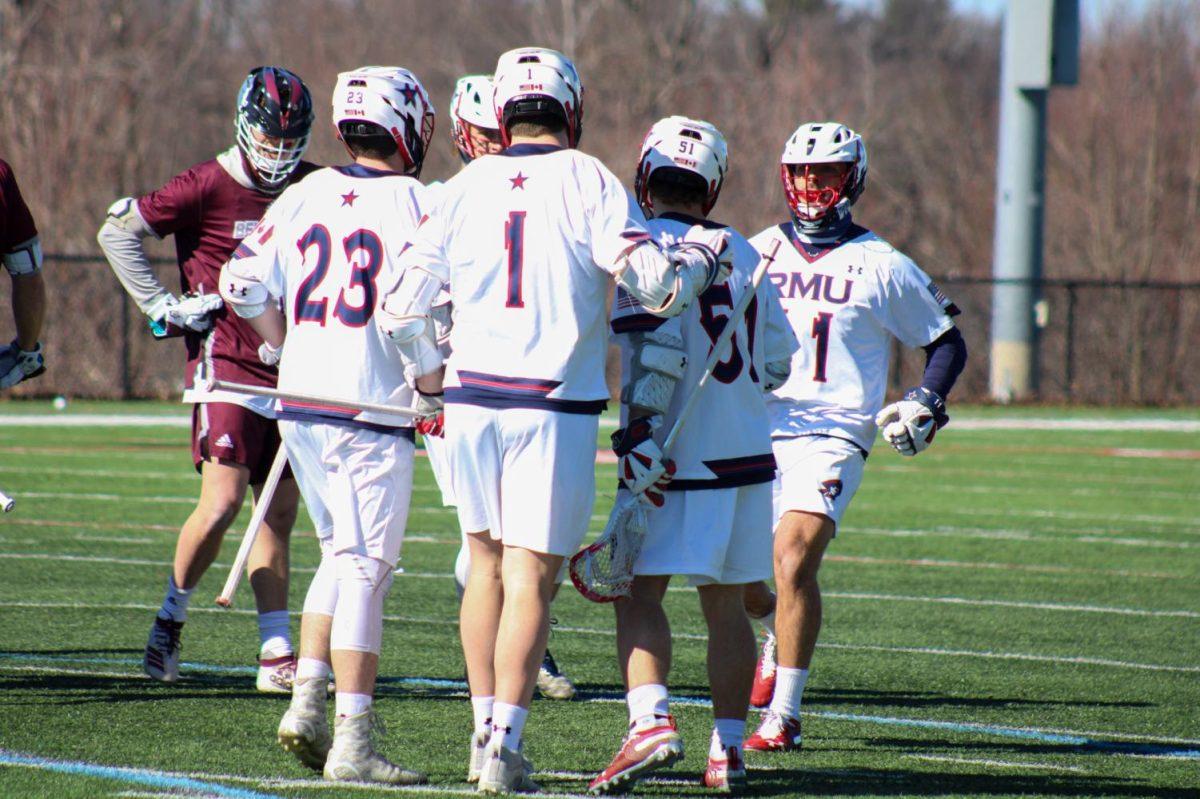 Mens lacrosse celebrates a goal against Bellarmine. Photo credit: Nathan Breisinger